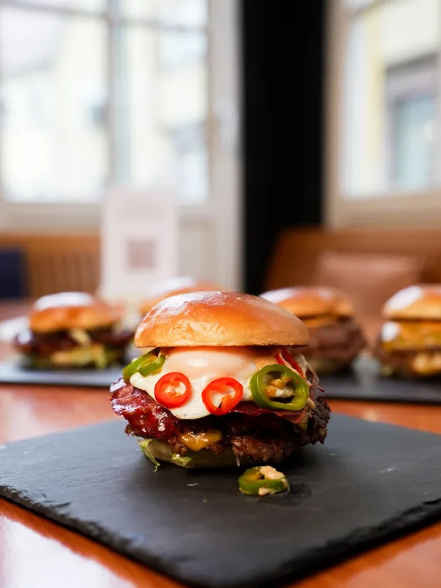 SmashBurger mit Spiegelei, Pastırma und Jalapeños auf Schieferplatte